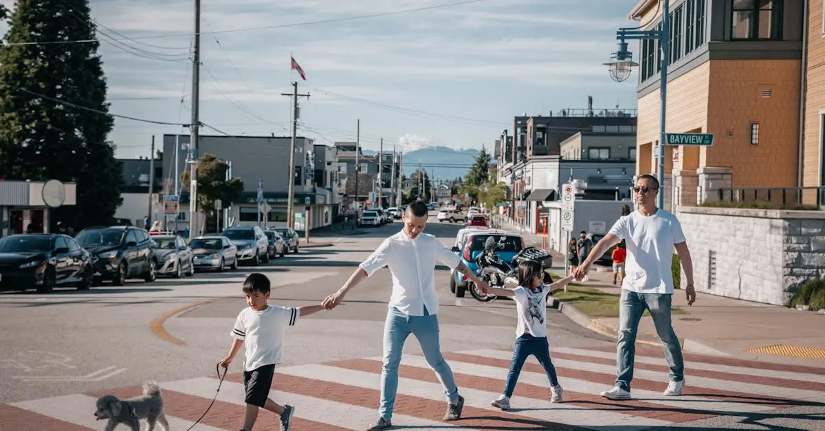 Family with children and small dog crossing city street during summer heatwave in the UK